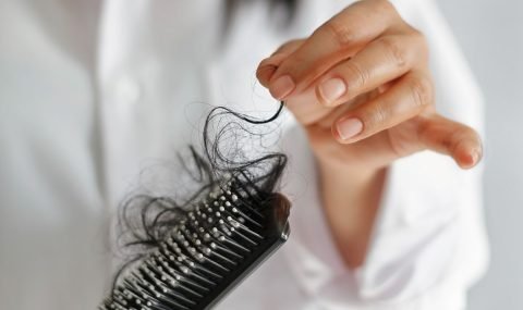 woman-losing-hair-on-hairbrush-in-hand-on-bathroom-royalty-free-image-1569427395